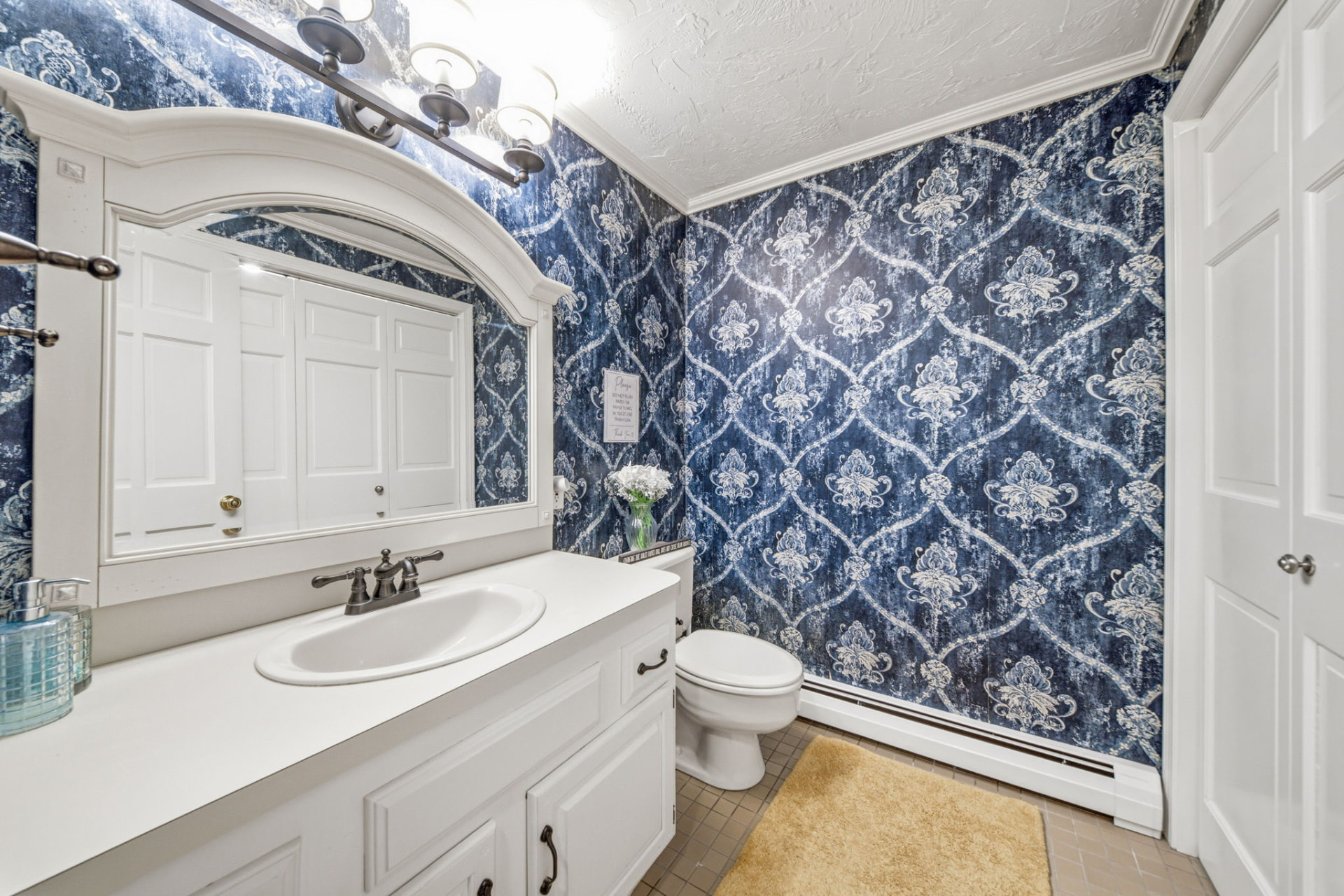 Full bathroom with custom vanity and statement wallpaper