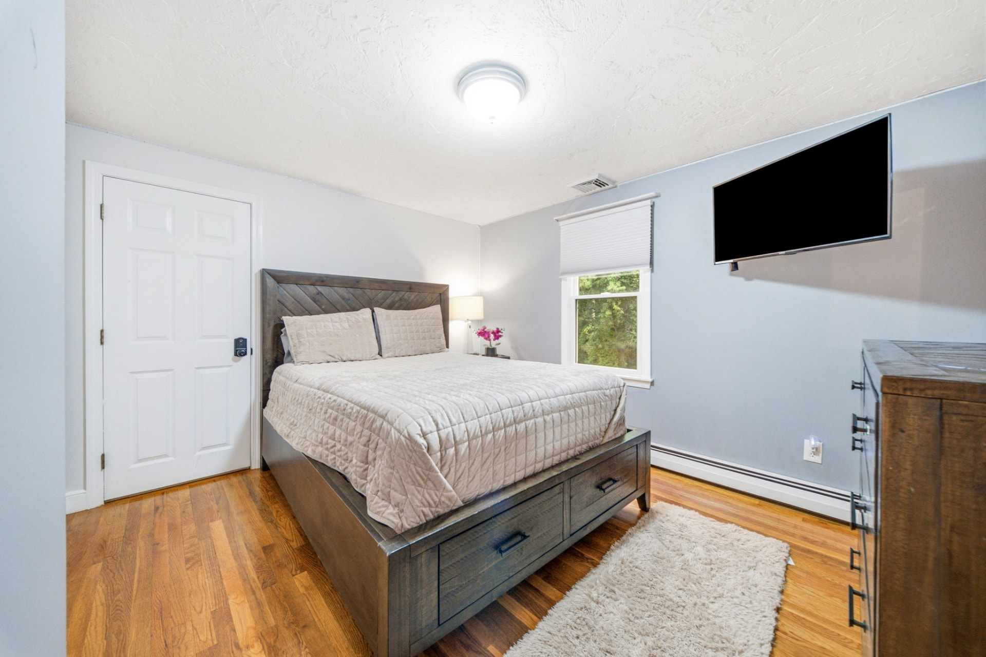 Guest bedroom with hardwood floors