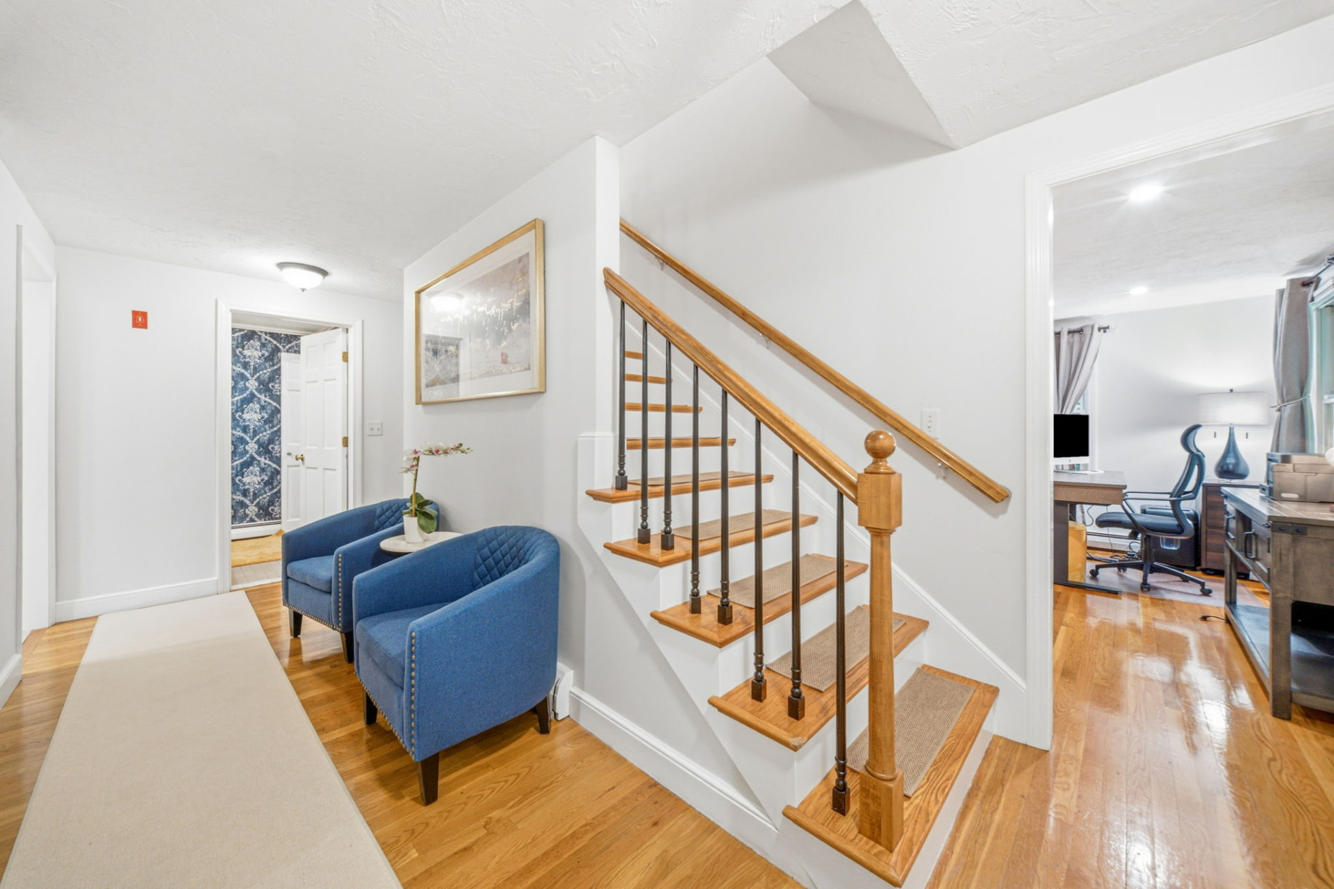 Entry foyer with hardwood floors and staircase