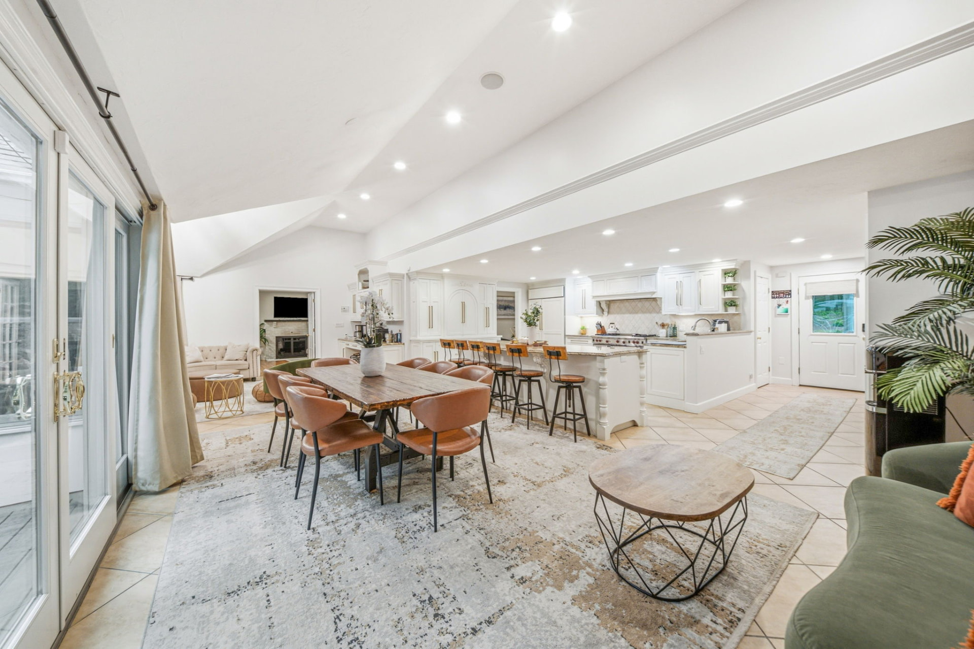 Open dining and kitchen great room with vaulted ceiling