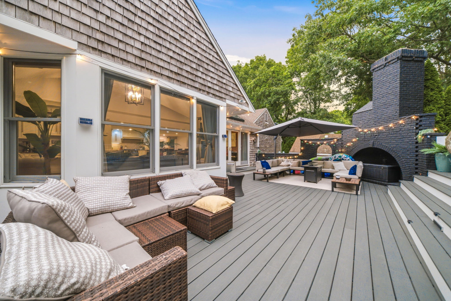 Composite deck with lounge seating, string lights and outdoor fireplace