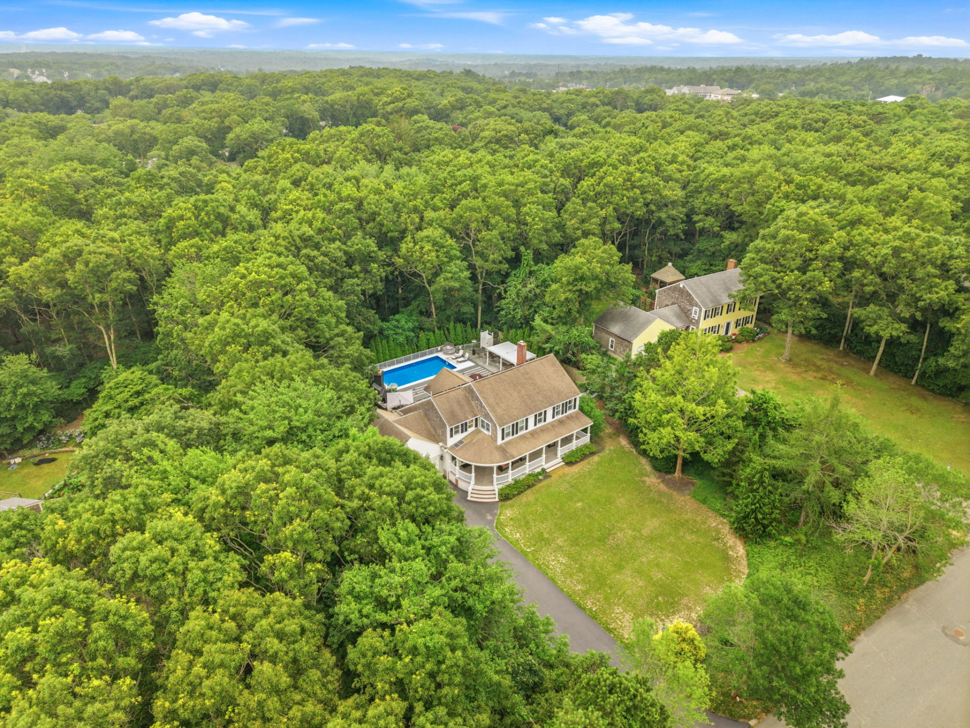 Aerial view of the estate surrounded by mature woodland