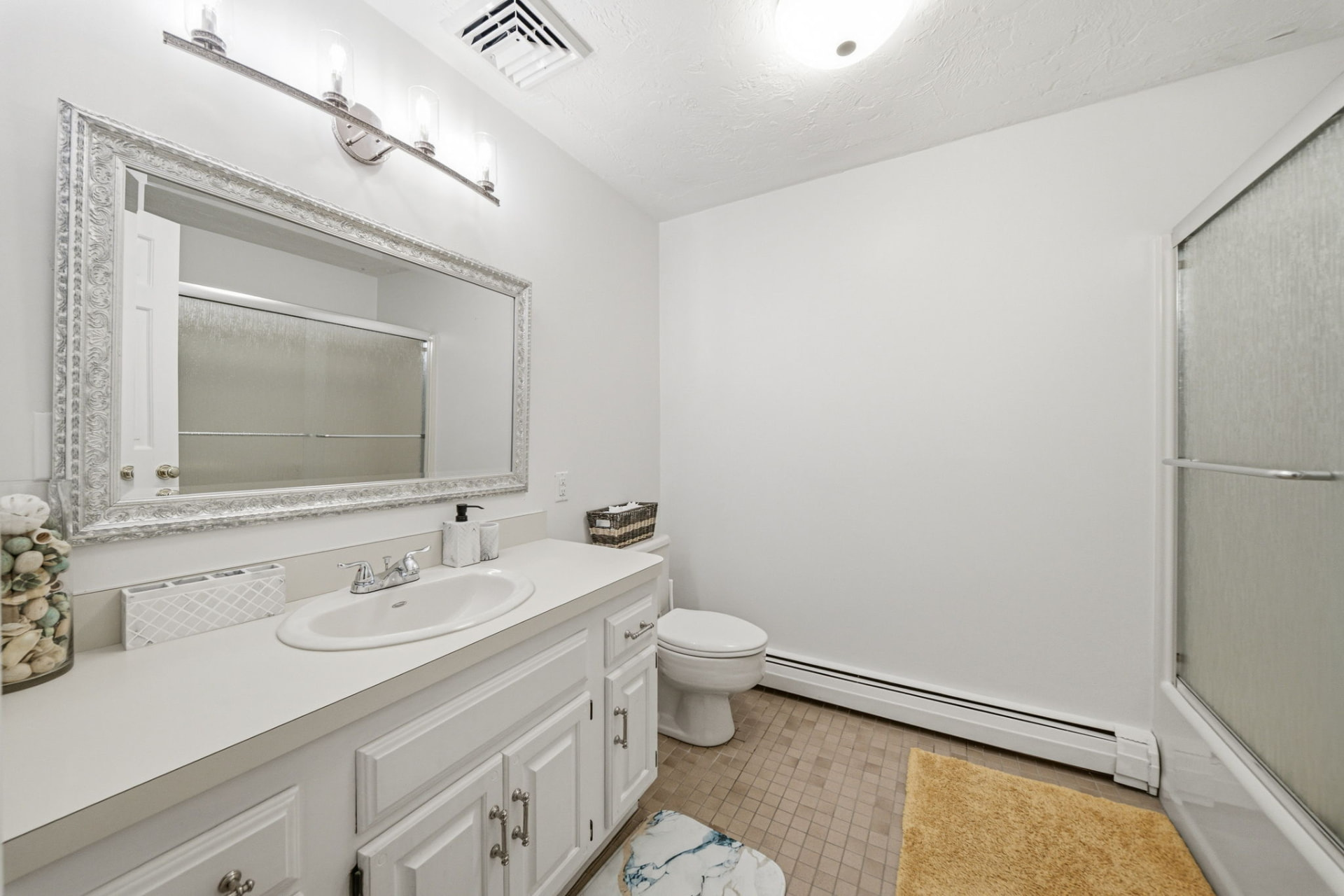 Full bath with tub-shower and white vanity